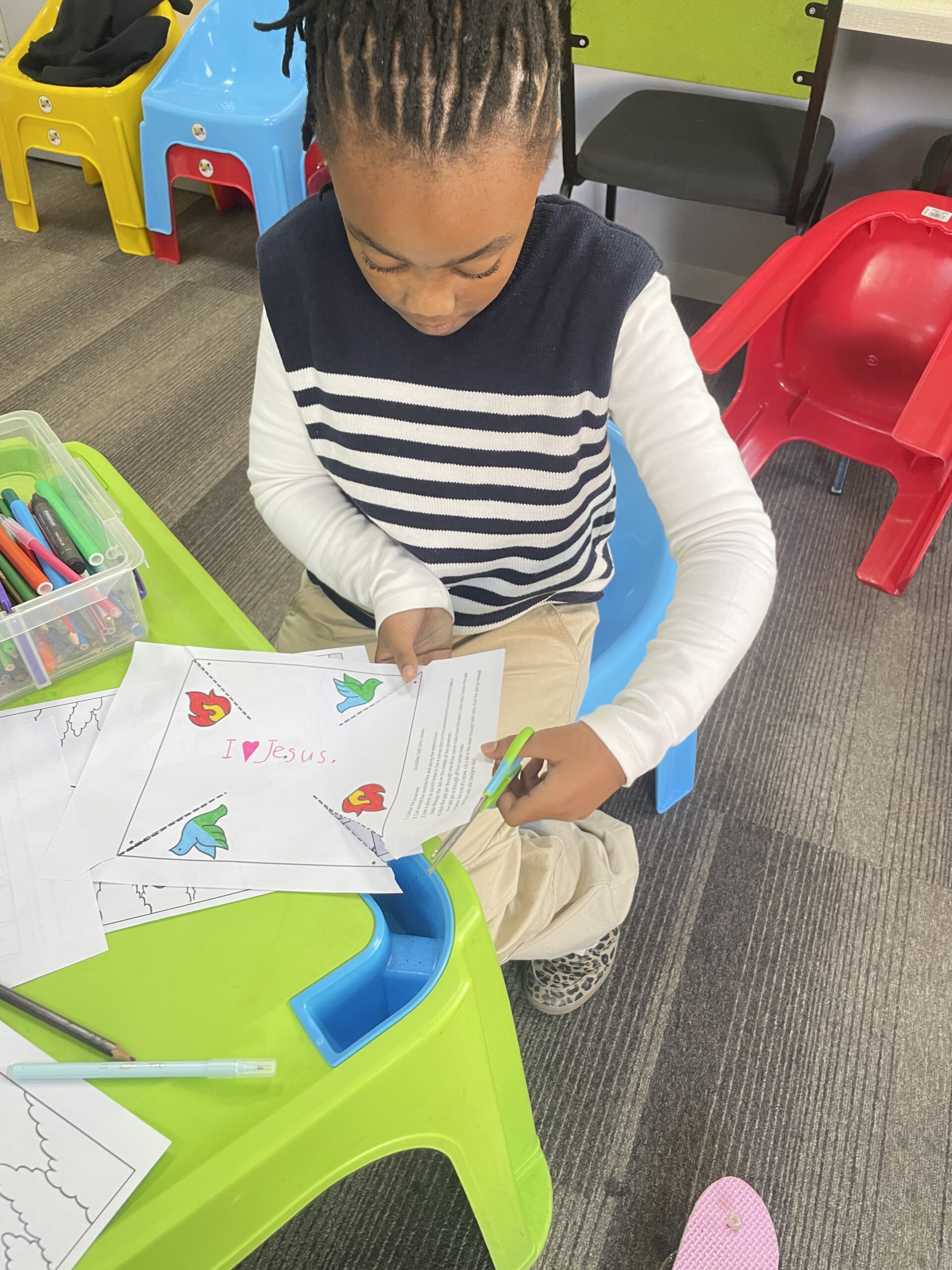 Boy crafting at green table