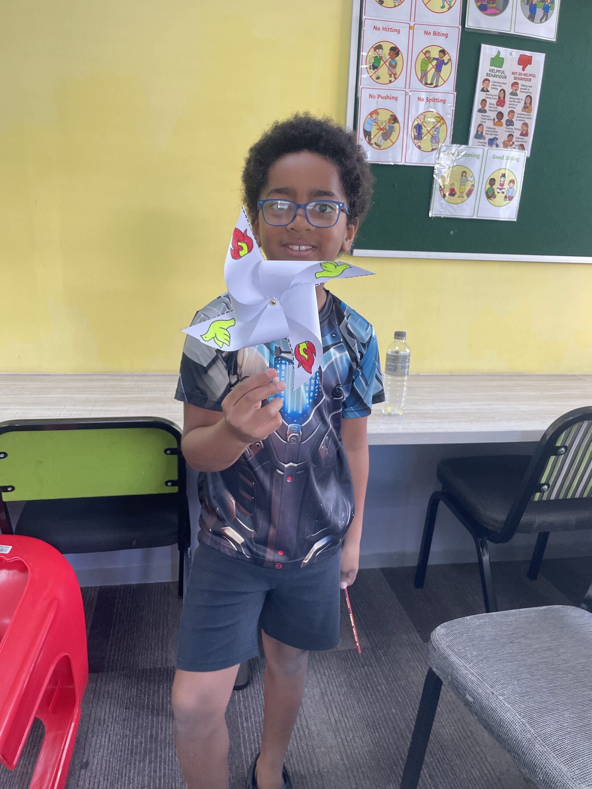 Boy holding pinwheel craft