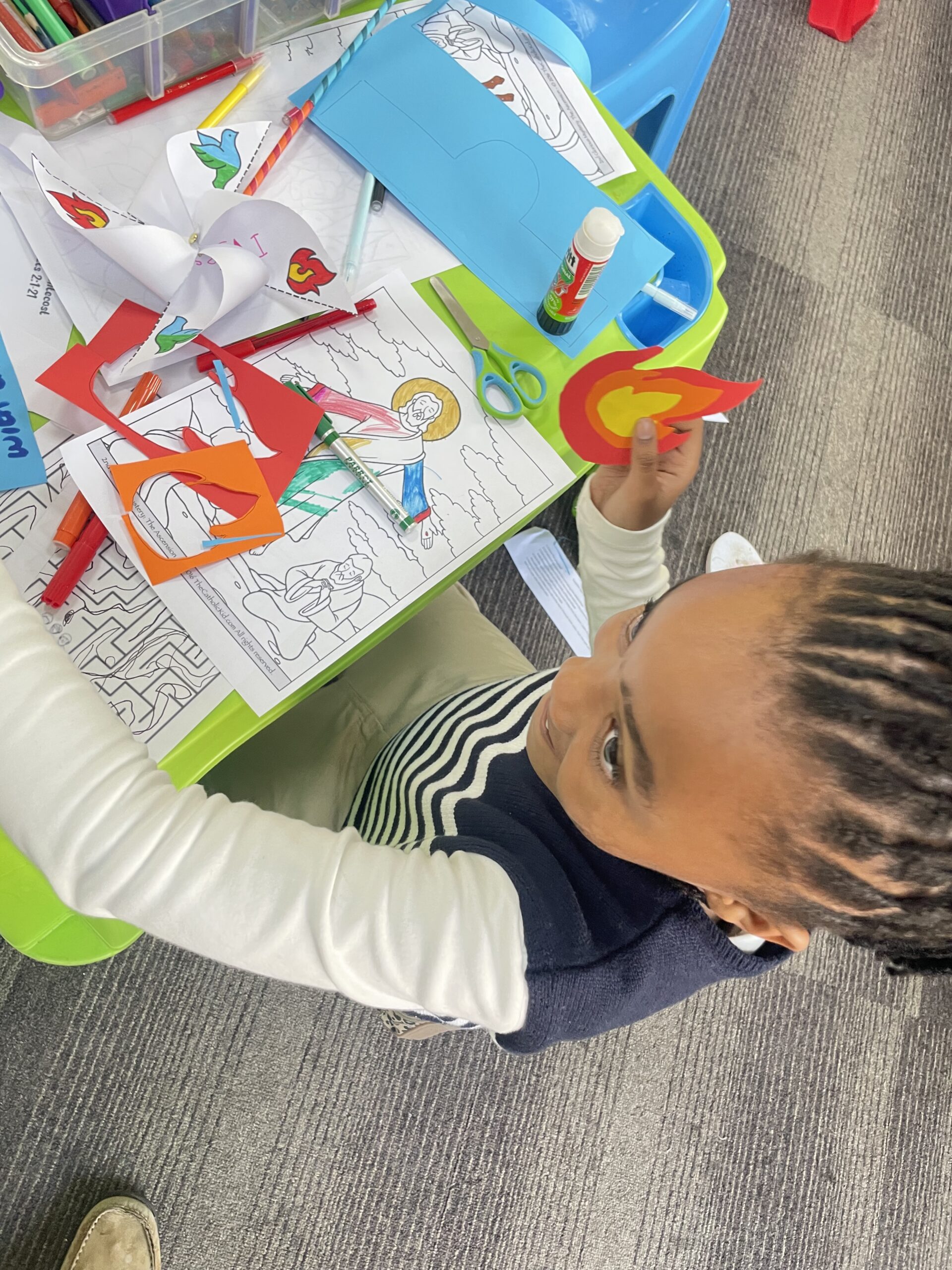 Child holding flame of Holy Spirit craft - Pentecost