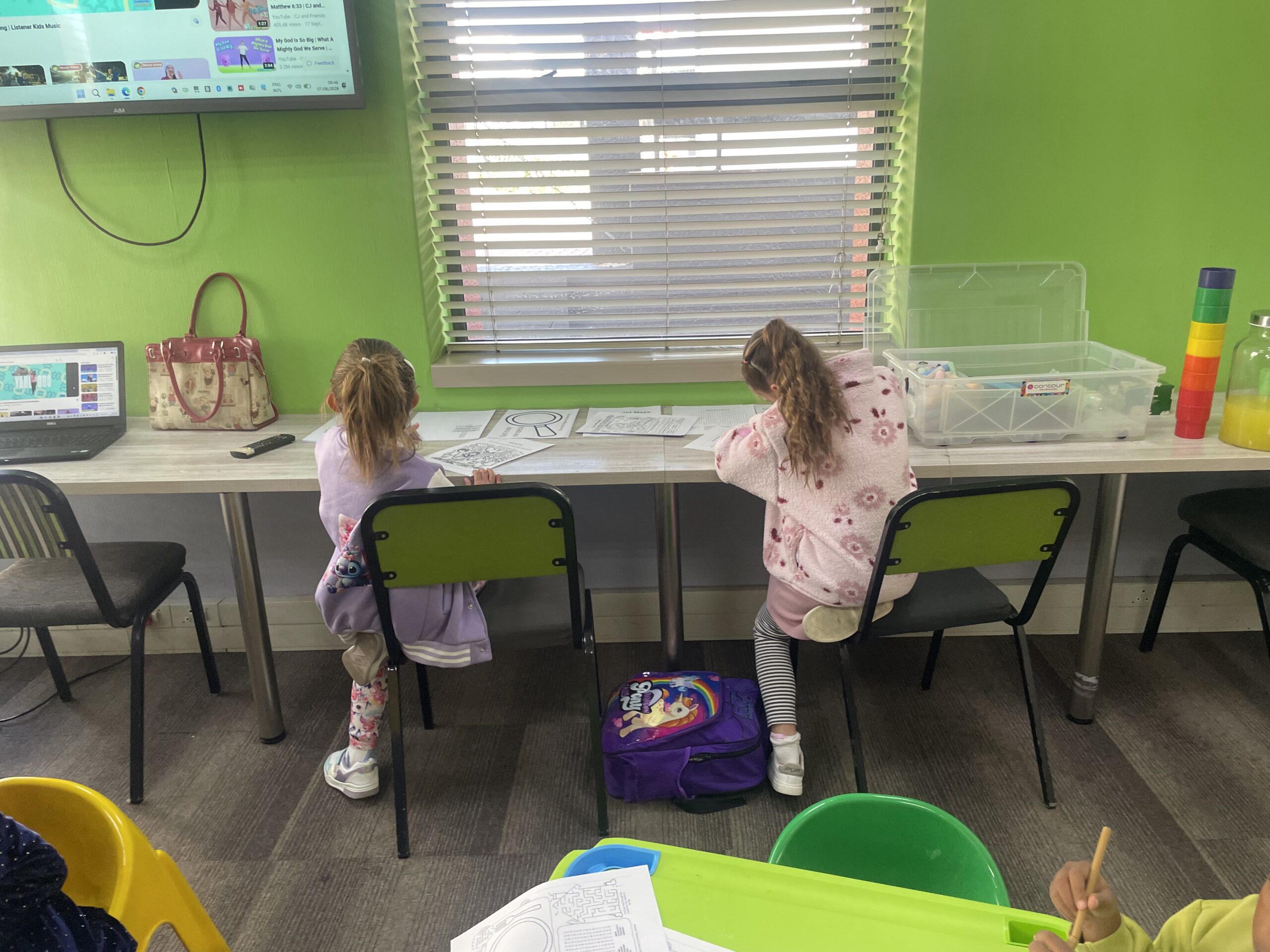 Kids at back tables working