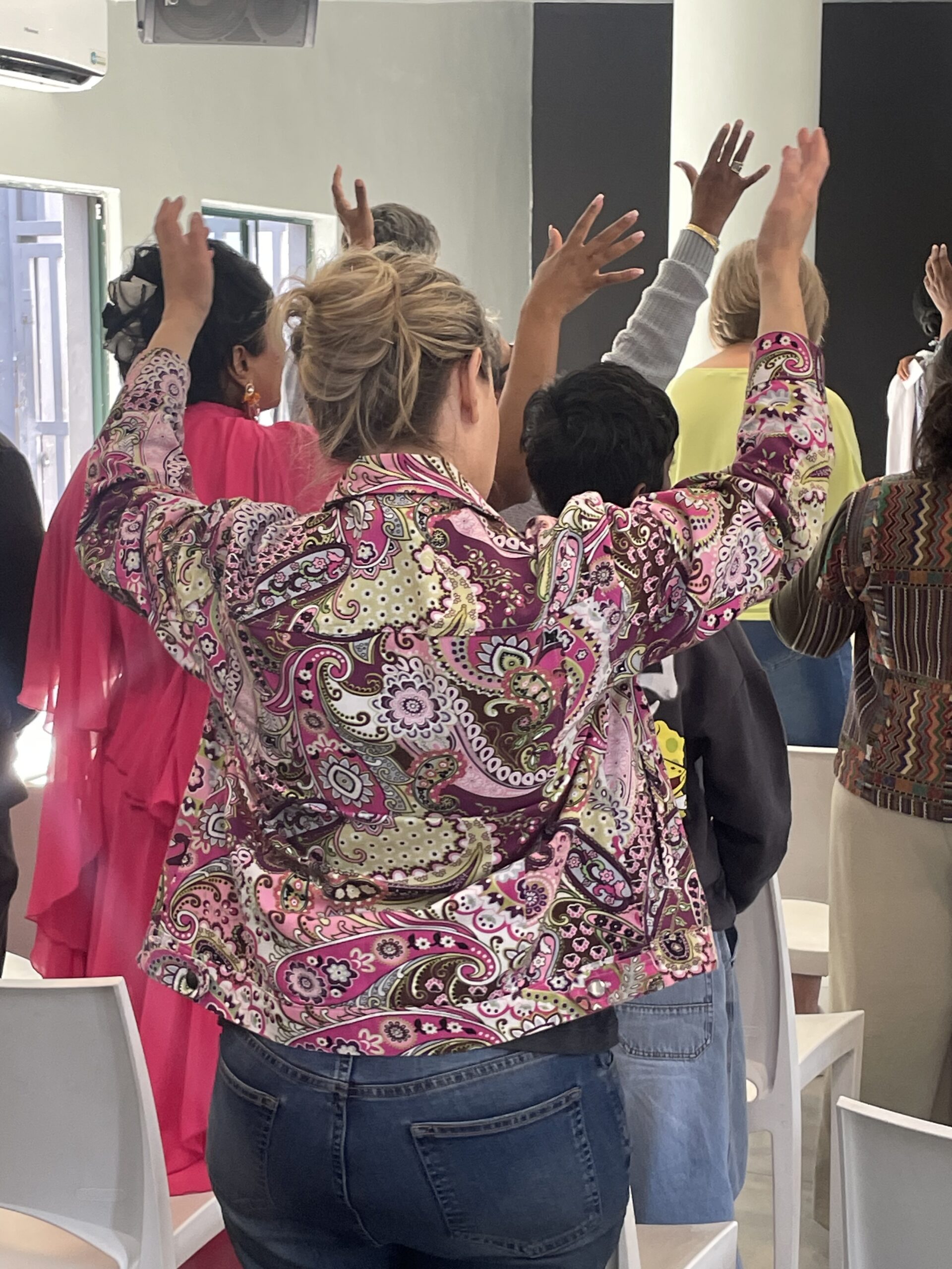 Congregation worshipping with hands raised